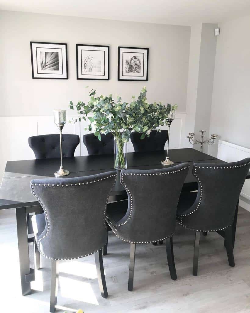 black dining room table and chairs framed wall art