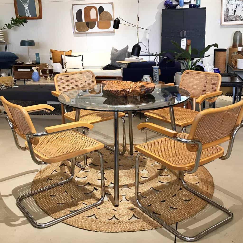 glass table and vintage chairs in open dining room 