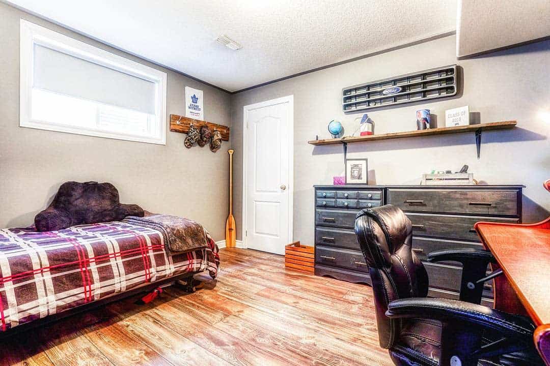 large basement bedroom with desk and chair