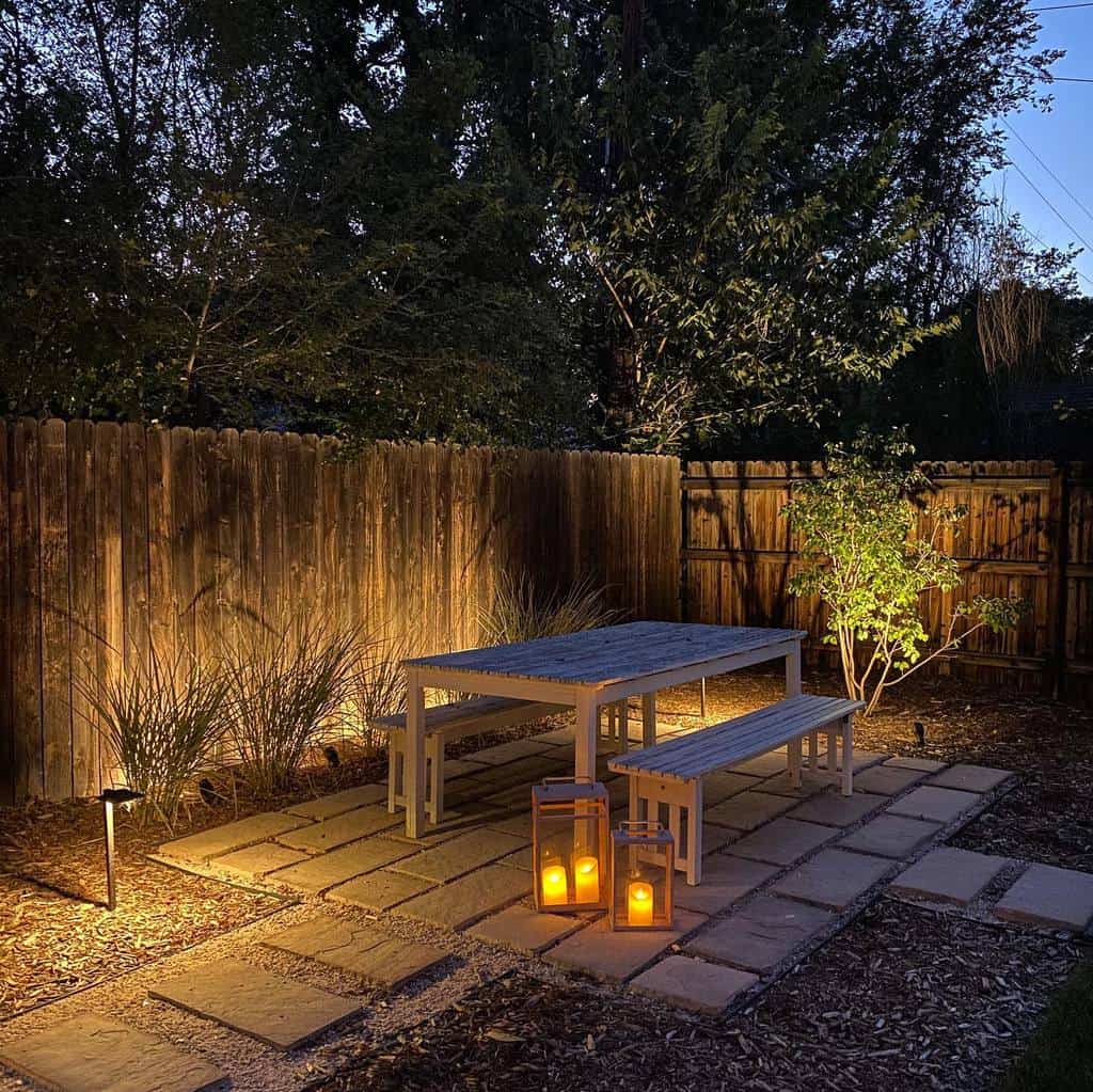 small stone patio with wood table and chairs 