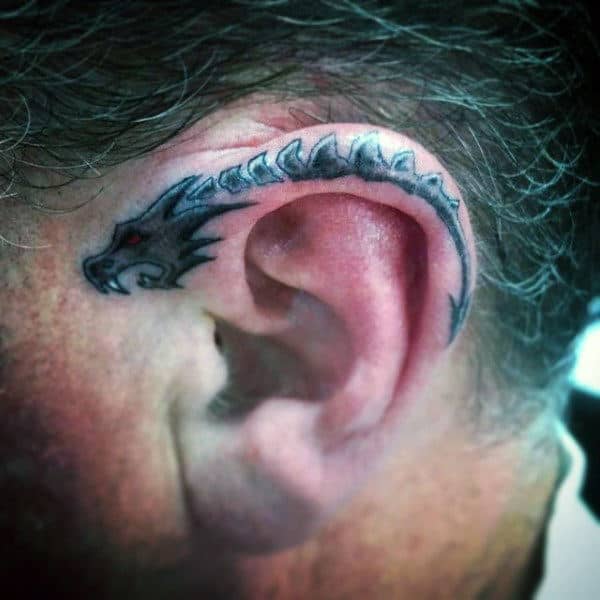 Single needle dragonfly tattoo behind the ear