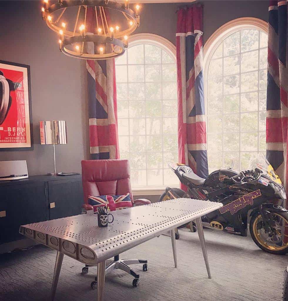 english flag drapes modern office with motorcylce metal desk red chair chandelier