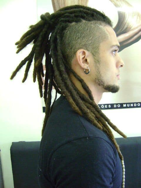 A black man wearing dreadlocks on top paired with shaven and dyed sides