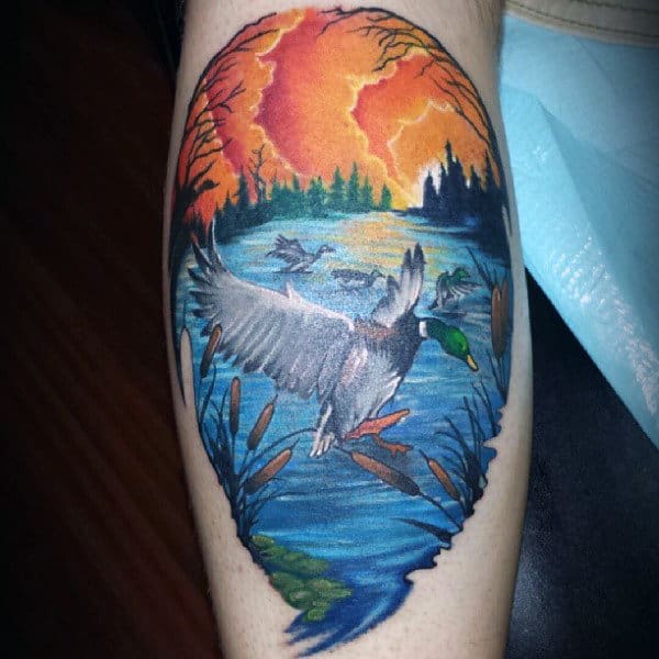Duck Flying Over Water Sunset Background Tattoo For Guy