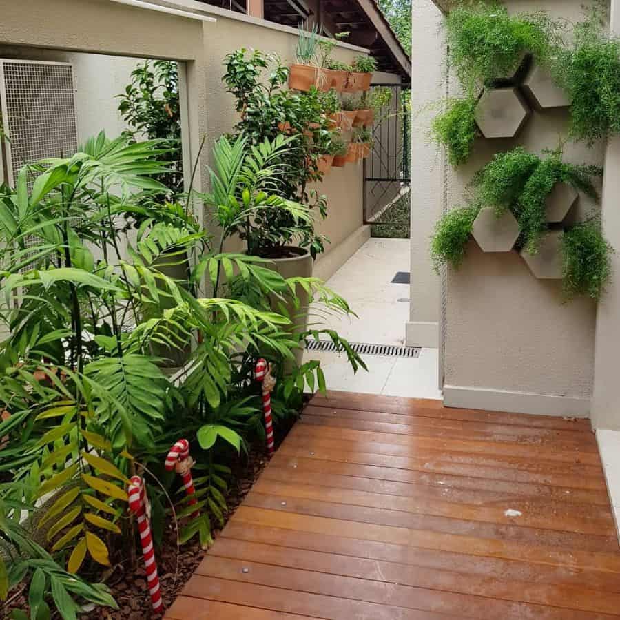 small outdoor patio with wood deck and green plants 