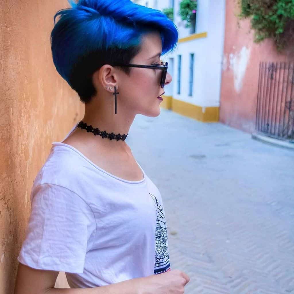 A bob haircut for women with a bold shade of electrifying blue worn with sunglasses