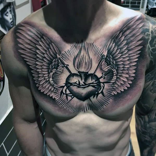 Neotraditional sacred flaming heart and wings tattoo on