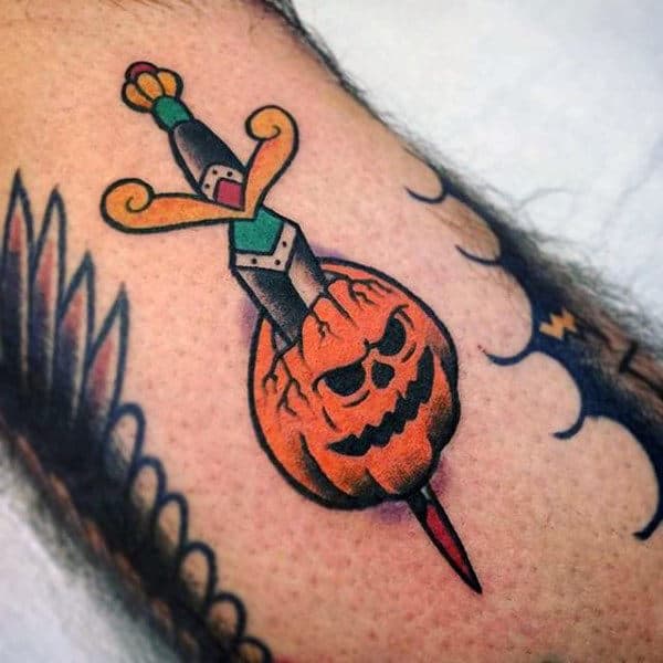 Ethnic Knife Slicing Through Pumpkin Halloween Tattoo Male Forearms
