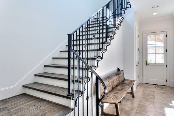 traditional wooden staircase with metal railing 