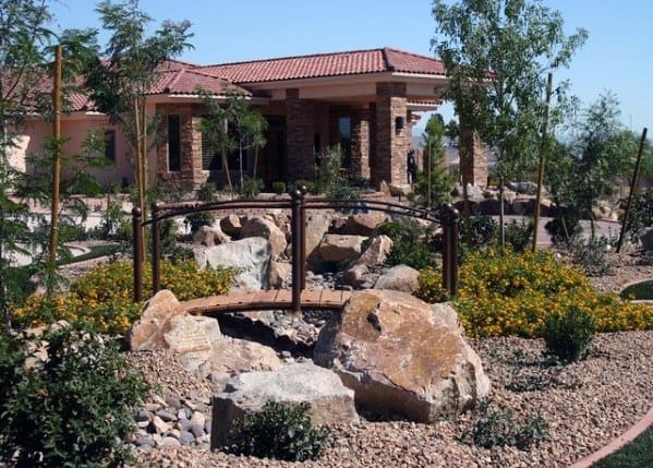 boulder rock garden with bridge over stream 