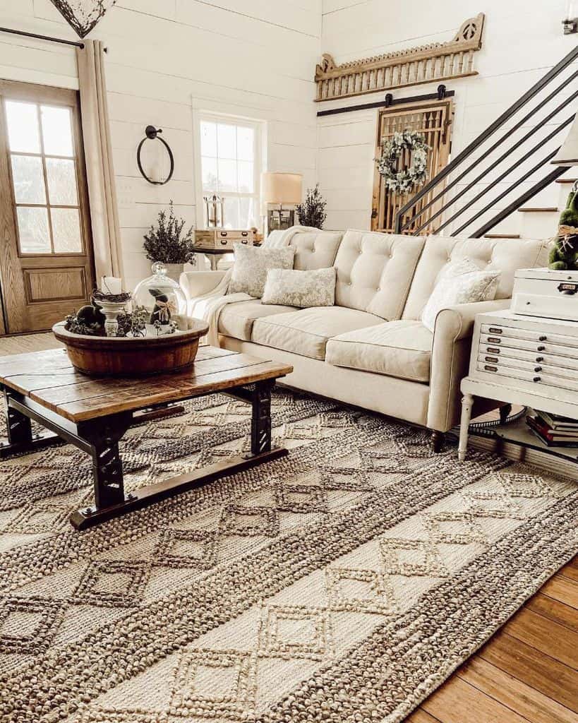 country chic farmhouse living room with white shiplap walls and wood coffee table 