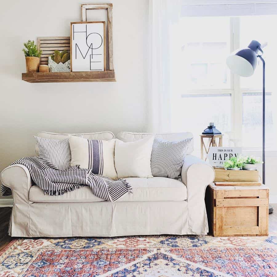 light farmhouse living room with white sofa and blue floor lamp 