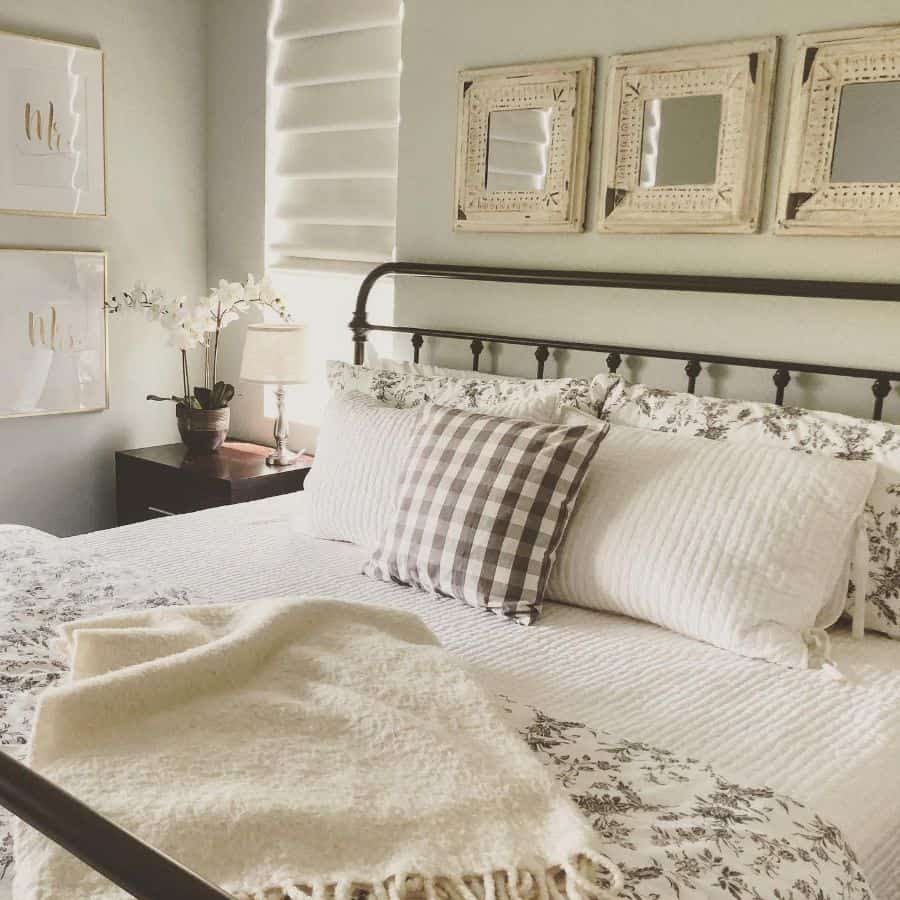 farmhouse small master bedroom with cast iron bed frame 