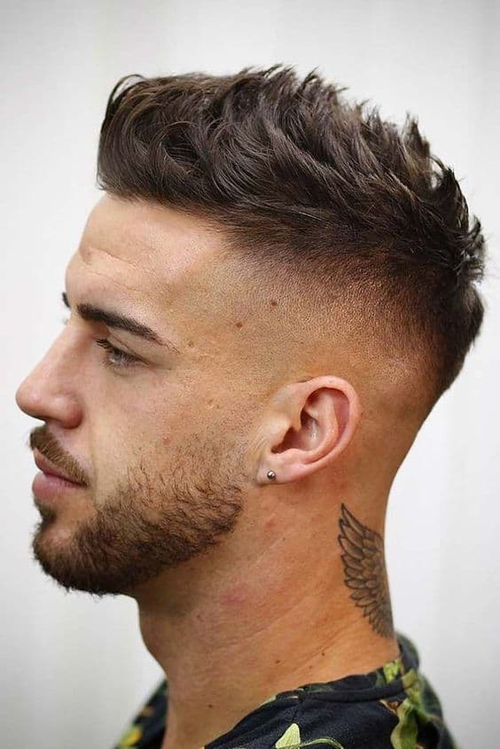 faux hawk bald fade with brown hair and neck tattoo