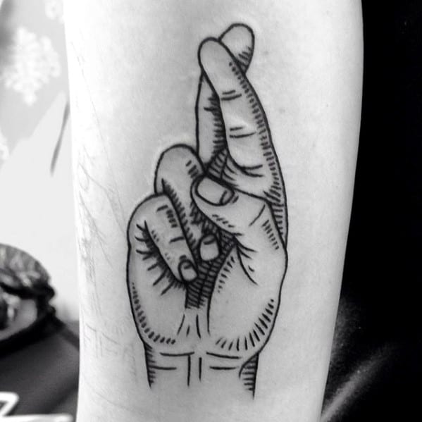 Fingers Crossed Tattoo Design On Mans Forearm.