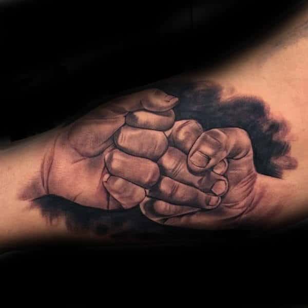 fist bump brother arm tattoo on gentleman