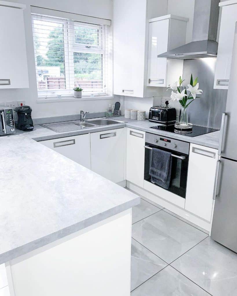 all white-kitchen large polished gray floor tiles