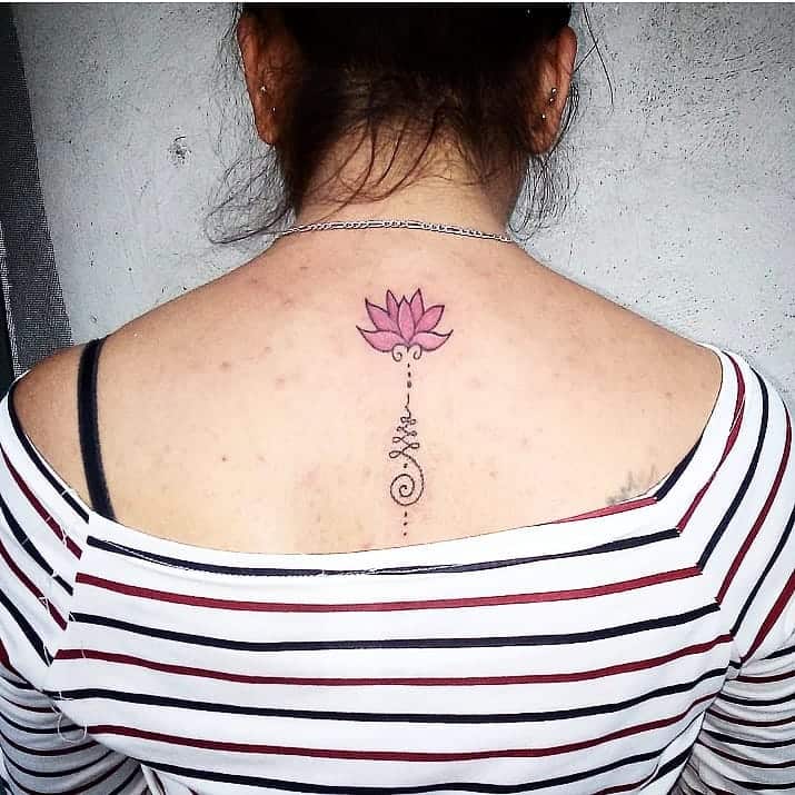 Tattoo of a lotus unalome located on the upper back.