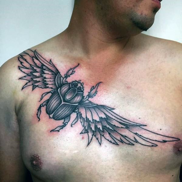 flying scarab bettle with wings mens chest tattoo