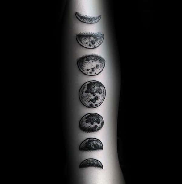 Moon phases tattoo on the upper arm