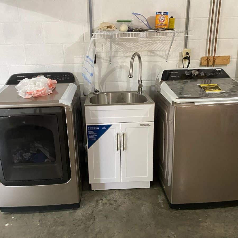 free standing laundry room sink between washer and dryer