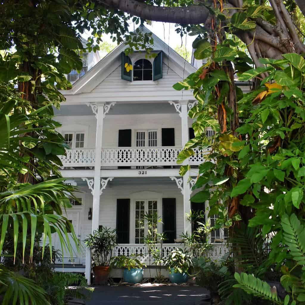 white exterior cottage-style house leafy garden