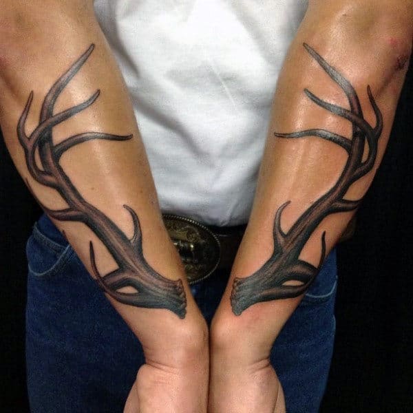 Gentleman With Antler Tattoos On Forearms