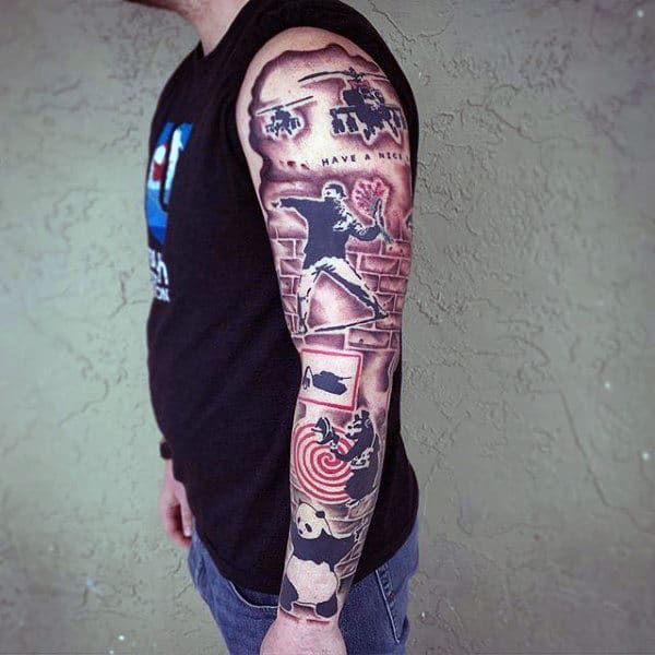 Gentleman With Full Sleeve Tattoo Of Banksy Street Art
