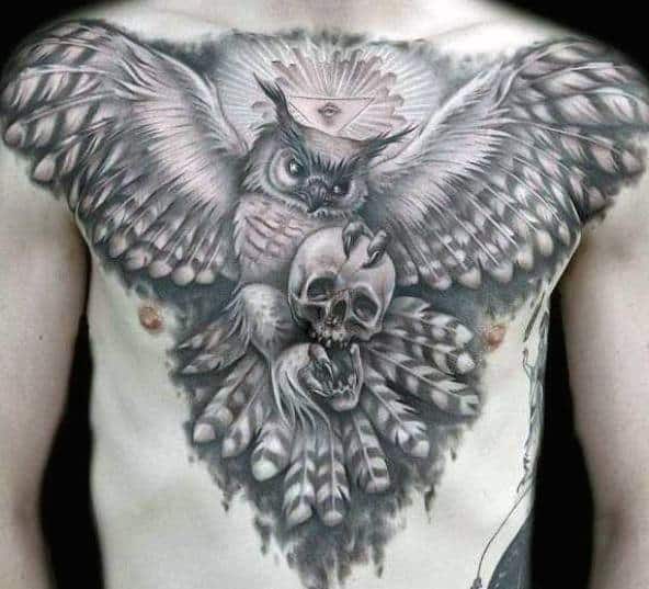 Gentleman With Owl Flying With Skull Chest Tattoo