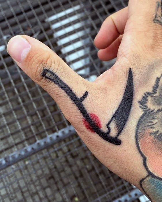 Gentleman With Scythe Tattoo On Finger