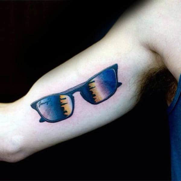 Gentleman With Sunglasses Building Skylien Tattoo On Bicep