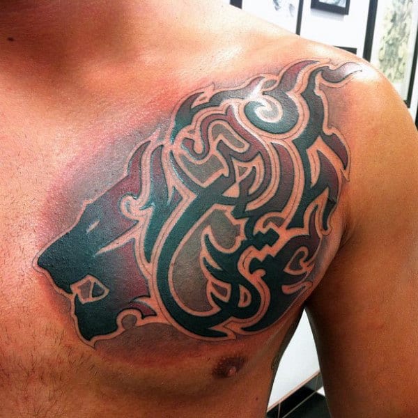 Gentleman With Tribal Lion Red And Black Ink Tattoo On Chest And Shoulder