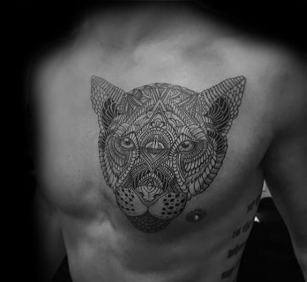 Gentleman With Tribal Mountain Lion Tattoo On Upper Chest