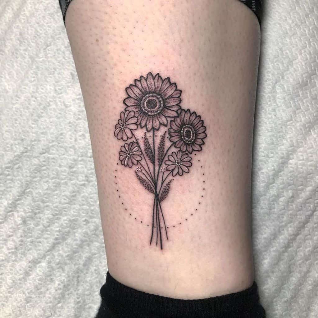 Calf tattoo black and grey fine line stipple shading geometric circle daisy