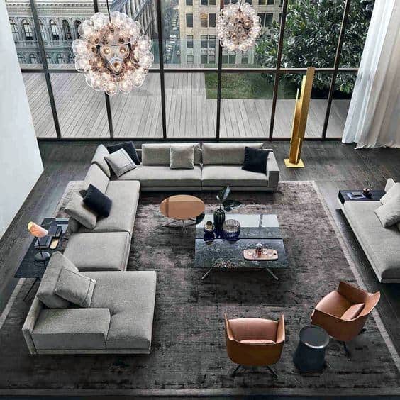 high ceiling apartment living room gray sofas accent chairs chandeliers