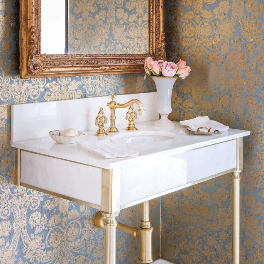 elegant gold accent powder room with wallpaper