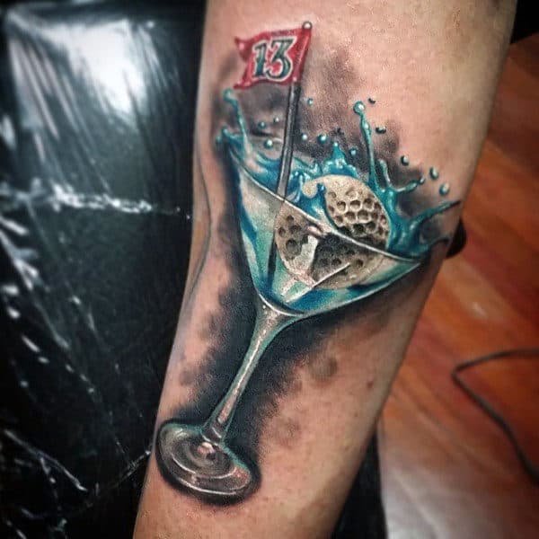 Golf Ball Floating In Cool Drink Tattoo Male Forearm