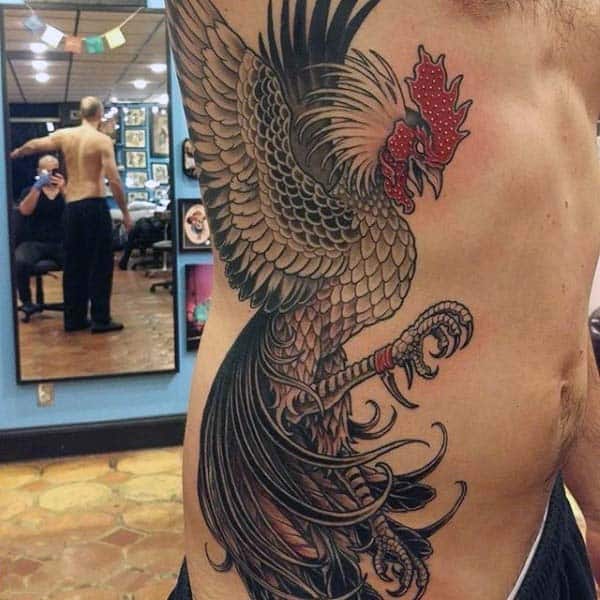 Grabbing Rooster Tattoo For Men Black Ink With Red Features On Side