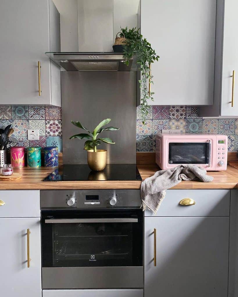 gray kitchenette pattern colorful backsplash tile pink microwave