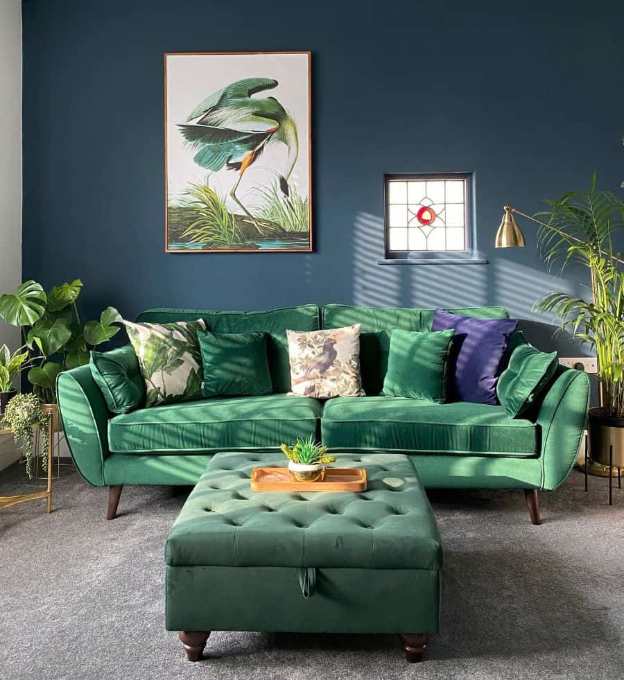 blue wall living room green couch ottoman plants