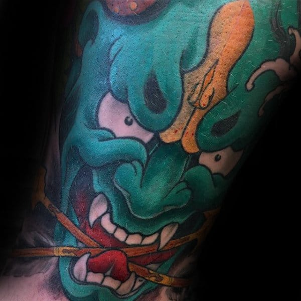 Green Hannya Mask With Arrows In Mouth Male Tattoo On Arm