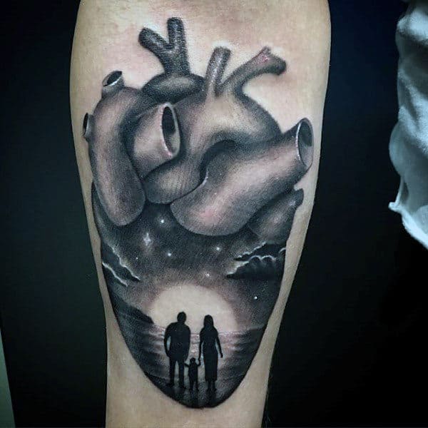 Grey Anatomical Heart With Family On A Beach Tattoo Guys Arms