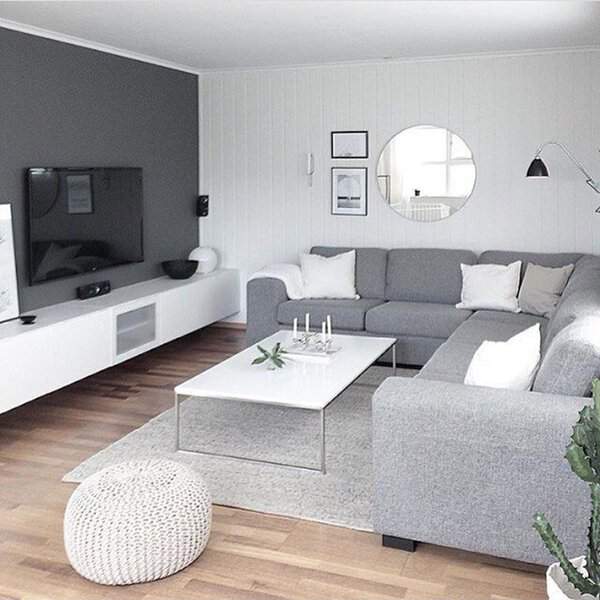Grey and white living room with a modern sectional, minimalist decor, and a sleek media unit.