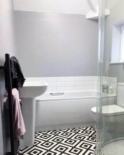 minimalist bathroom with pattern black and white tiles 