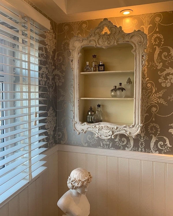 french style bathroom with shelves and statue