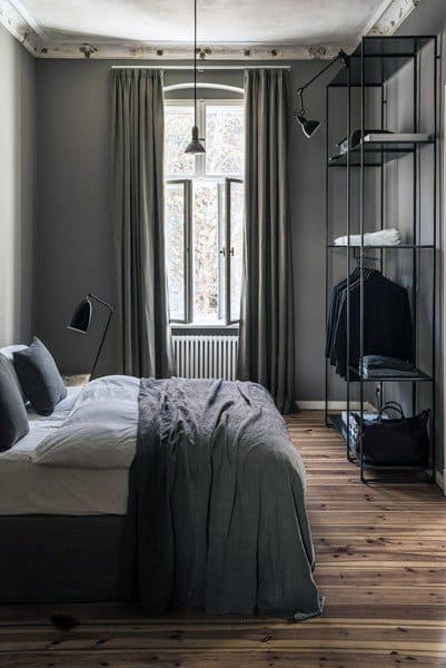 small modern bedroom metal clothes rack hardwood floors