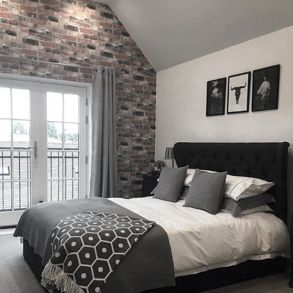 simple black and white bedroom exposed brick wall framed wall art