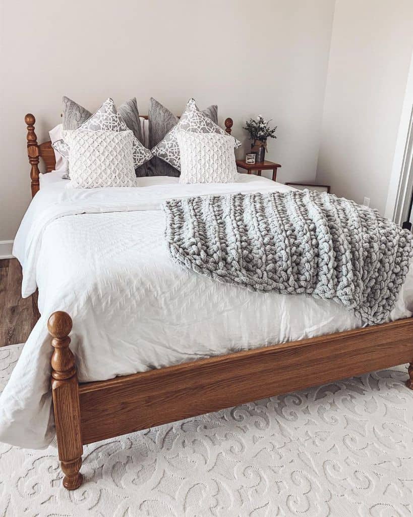 white guest bedroom with wood bed frame