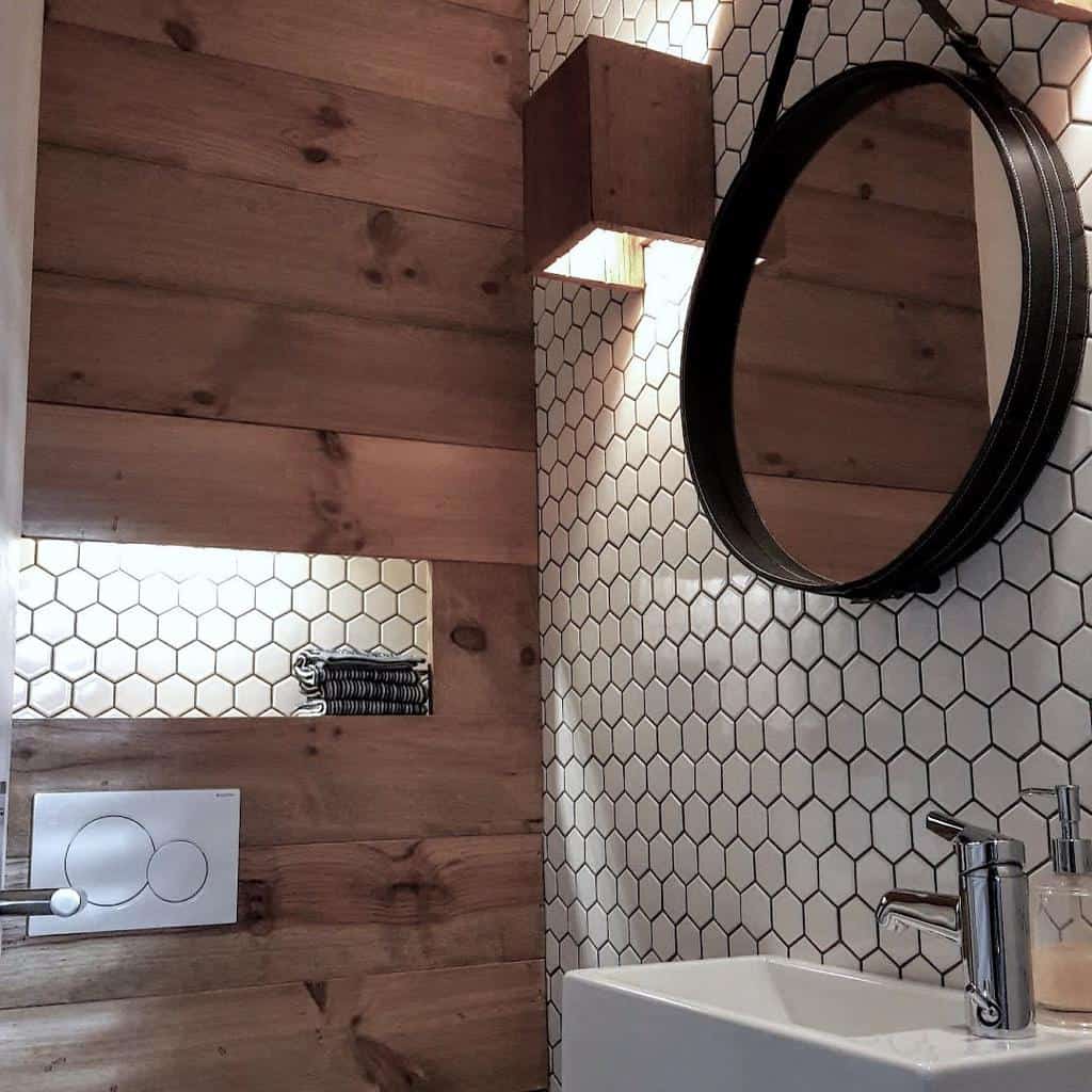 natural wood panel hexagonal white tile bathroom round black rim mirror white sink 