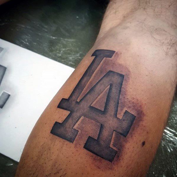 Guy With 3d Stone Los Angeles Dodgers Tattoo Design On Leg Calf